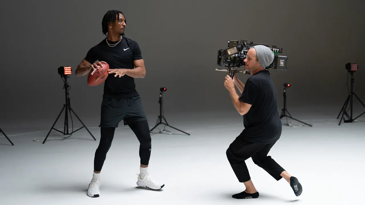 Behind the scenes — athlete football shoot with handheld camera on studio set